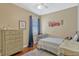 This bedroom features wood floors, a window, and cozy decor at 13111 Meergate Cir, Orlando, FL 32837