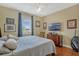 This bedroom features wood floors, a window, a ceiling fan, and decor at 13111 Meergate Cir, Orlando, FL 32837