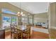 Bright dining room featuring a wooden table with seating for six and elegant chandelier lighting at 13111 Meergate Cir, Orlando, FL 32837