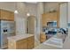 Bright kitchen featuring stainless appliances, a breakfast bar, and tile floors at 13111 Meergate Cir, Orlando, FL 32837