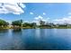 Picturesque view of a tranquil lake with a fountain, surrounded by lush greenery and beautiful homes at 13111 Meergate Cir, Orlando, FL 32837