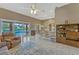 The living room offers access to the pool area, and features a ceiling fan and built-in shelving at 13111 Meergate Cir, Orlando, FL 32837