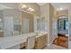 Bright main bathroom showcasing dual sinks, generous vanity space, and ensuite access at 13111 Meergate Cir, Orlando, FL 32837
