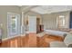 Spacious main bedroom boasts gleaming hardwood floors and ensuite bathroom access at 13111 Meergate Cir, Orlando, FL 32837