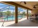 Covered patio with a pool overlooking a serene lake, perfect for outdoor relaxation and entertaining at 13111 Meergate Cir, Orlando, FL 32837