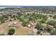 Aerial shot of a home on a large property, featuring a pool and expansive green space at 13124 Filly Ct, Windermere, FL 34786