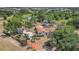 An aerial view of the landscaped property with its pool, detached garage and pond nearby at 13124 Filly Ct, Windermere, FL 34786
