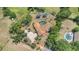 This aerial view showcases the home and pool, surrounded by lush landscaping and trees at 13124 Filly Ct, Windermere, FL 34786