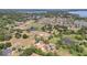View of a home in a rural setting, featuring mature landscaping, several ponds, and an access road at 13124 Filly Ct, Windermere, FL 34786