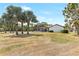 Expansive backyard with lush trees, a manicured lawn, and a pool area, perfect for outdoor enjoyment at 13124 Filly Ct, Windermere, FL 34786