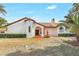Charming Spanish-style home with a terracotta roof, water fountain, arched doorway and lush landscaping at 13124 Filly Ct, Windermere, FL 34786