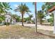 A home with a brick driveway, large yard, mature palm trees and lush landscaping at 13124 Filly Ct, Windermere, FL 34786