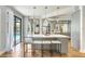 Modern kitchen featuring an island with seating, gray cabinetry, and stainless steel appliances at 13124 Filly Ct, Windermere, FL 34786