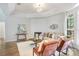 Bright living room featuring tray ceiling, hardwood floors, fireplace, and large windows at 13124 Filly Ct, Windermere, FL 34786