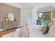 Comfortable main bedroom featuring a dresser, plush bedding, and a view to the pool at 13124 Filly Ct, Windermere, FL 34786