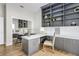 Stylish office features custom gray shelving, desk, cabinets, with a white countertop, and wood floors at 13124 Filly Ct, Windermere, FL 34786
