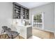Well-lit office space with custom built-in shelving, a spacious desk, and a window for natural light at 13124 Filly Ct, Windermere, FL 34786