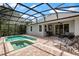 Backyard view of swimming pool, spa, outdoor seating, grill, outdoor tv, and lush landscaping at 13609 Riggs Way, Windermere, FL 34786