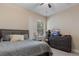 Neutral colored bedroom with ceiling fan, window, and wood-look floors at 13609 Riggs Way, Windermere, FL 34786