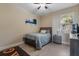 Bedroom features a neutral color scheme, ceiling fan, window, and closet at 13609 Riggs Way, Windermere, FL 34786
