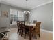 Inviting dining room featuring a classic chandelier, a view to the exterior, and neutral wall color at 13609 Riggs Way, Windermere, FL 34786