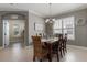 Open-concept dining area with chandelier and access to adjacent rooms enhances the home's entertaining capabilities at 13609 Riggs Way, Windermere, FL 34786