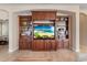 Detailed view of a custom built-in entertainment center with shelving and cabinets for storage and display at 13609 Riggs Way, Windermere, FL 34786