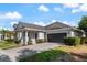 Well-manicured lawn accents this delightful home's exterior, complete with a two-car garage at 13609 Riggs Way, Windermere, FL 34786