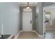 Welcoming foyer with neutral tile flooring and a view into the adjacent living spaces at 13609 Riggs Way, Windermere, FL 34786