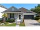 Charming single-story home featuring a well-maintained front yard and attached two-car garage at 13609 Riggs Way, Windermere, FL 34786
