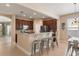 Kitchen showcases stainless appliances, a breakfast bar with seating, and dark wood cabinets at 13609 Riggs Way, Windermere, FL 34786