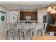 Open kitchen with stainless steel appliances, dark cabinetry, and a breakfast bar with seating at 13609 Riggs Way, Windermere, FL 34786