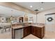 Kitchen and dining area featuring an island with seating and views to the living room at 13609 Riggs Way, Windermere, FL 34786
