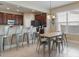 Open-concept kitchen and dining area with stainless appliances and ample seating at 13609 Riggs Way, Windermere, FL 34786