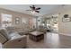 Comfortable living room with a sectional sofa, wood floors, and a sliding glass door to the patio at 13609 Riggs Way, Windermere, FL 34786