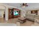 Open floor plan showing the living room with entertainment center and flows seamlessly into the kitchen and dining area at 13609 Riggs Way, Windermere, FL 34786