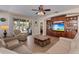Bright living room with a view of the pool through sliding glass doors and a built-in entertainment center at 13609 Riggs Way, Windermere, FL 34786