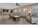 Spacious living room with modern furniture, wood-look flooring, and a view of the kitchen and dining area at 13609 Riggs Way, Windermere, FL 34786