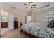 Spacious main bedroom featuring tray ceilings, ceiling fan, and ensuite bathroom access at 13609 Riggs Way, Windermere, FL 34786