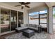 View of screened patio with outdoor ceiling fan, comfortable seating area, outdoor rug, and view to backyard at 13609 Riggs Way, Windermere, FL 34786