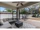 Screened patio with ceiling fan, cozy seating area with modern outdoor sectional and a view of the screened in pool area at 13609 Riggs Way, Windermere, FL 34786