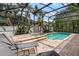 Enclosed backyard pool and spa surrounded by lush landscaping, perfect for outdoor relaxation at 13609 Riggs Way, Windermere, FL 34786