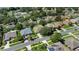 Bird's-eye view of a residential neighborhood, with manicured lawns and mature trees at 1375 Willow Wind Dr, Clermont, FL 34711