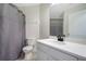 This bathroom features a new vanity with a stone countertop and a shower with a modern curtain at 1375 Willow Wind Dr, Clermont, FL 34711