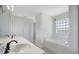 Well-lit bathroom with double sink vanity, soaking tub, and decorative window at 1375 Willow Wind Dr, Clermont, FL 34711