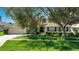 Charming single-Gathering home with well-manicured lawn and mature trees, showcasing lovely curb appeal at 1375 Willow Wind Dr, Clermont, FL 34711