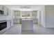 Neutral kitchen features stainless appliances, a window, an island, and lots of cabinets at 1375 Willow Wind Dr, Clermont, FL 34711