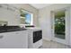 The laundry room has a new washer and dryer, window and a door to the outside at 1375 Willow Wind Dr, Clermont, FL 34711