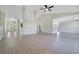 Spacious living area with modern flooring, an open layout, and access to kitchen at 1375 Willow Wind Dr, Clermont, FL 34711