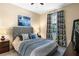 Comfortable bedroom featuring a gray headboard, accent pillows, and neutral decor at 1425 Thunderbird Rd, Davenport, FL 33896